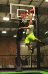 Boy Slam Dunking on Trampoline Basketball Court